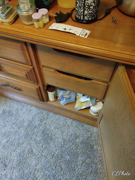 The cabinet inside the center of the dresser.