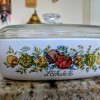 A Corningware casserole that has been overprinted with two different designs.
