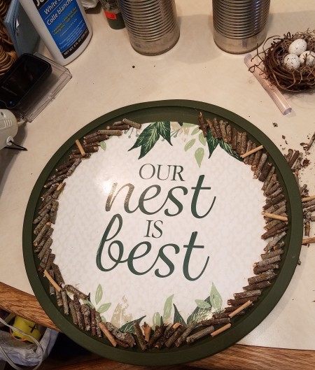 Adding wooden pieces to the edge of the pizza pan.