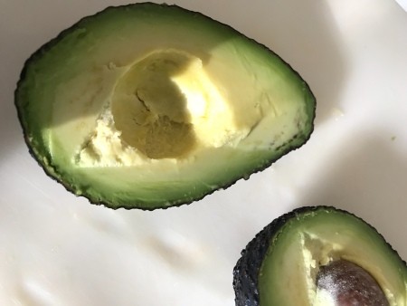 An avocado cut in half.