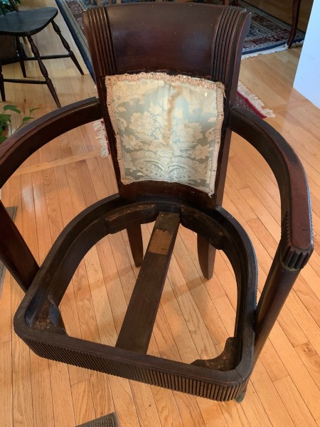 A wooden chair with the seat removed.