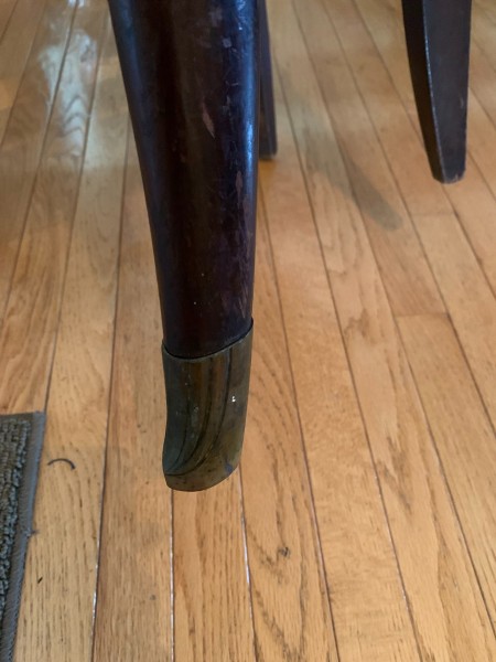 The legs of a wooden chair.