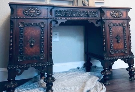 An ornately carved wooden desk.