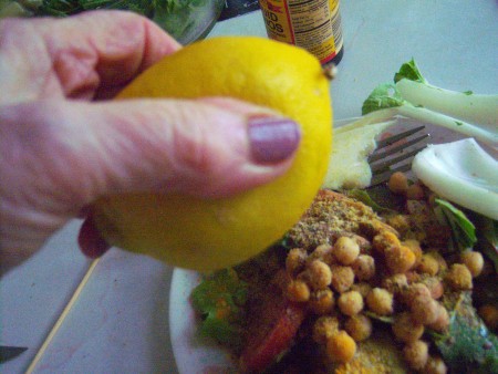 Squeezing lemon juice on food.