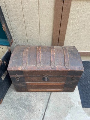 An old wooden steamer trunk.