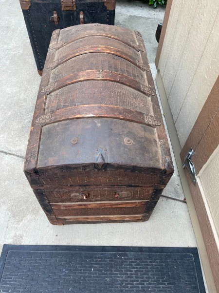 An old wooden steamer trunk.