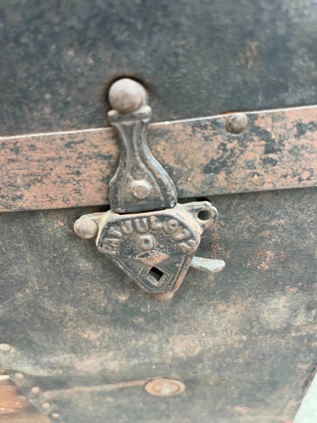 The clasp of an old steamer trunk.