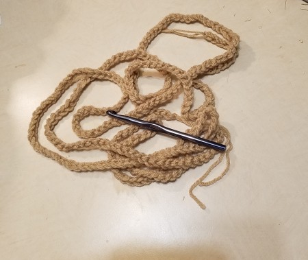 A crocheted chain in a wheat color.