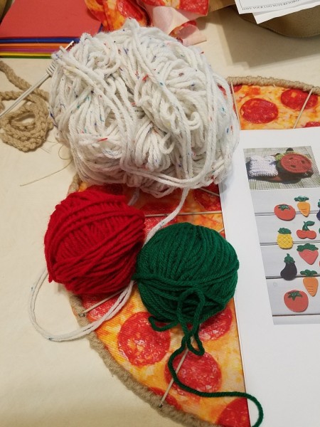 Balls of white, red and green yarn.