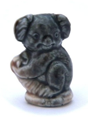 A small figurine of a koala.