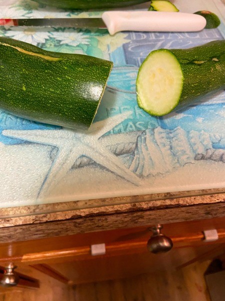 Cutting the zucchini into slices.