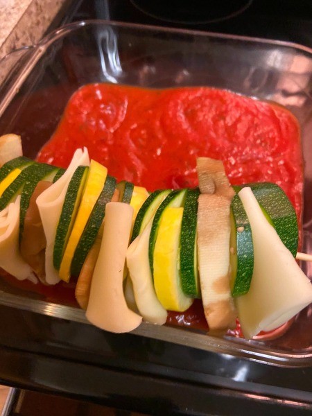 A completed kabob being placed in the pan.