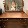 A vintage dresser with mirror.