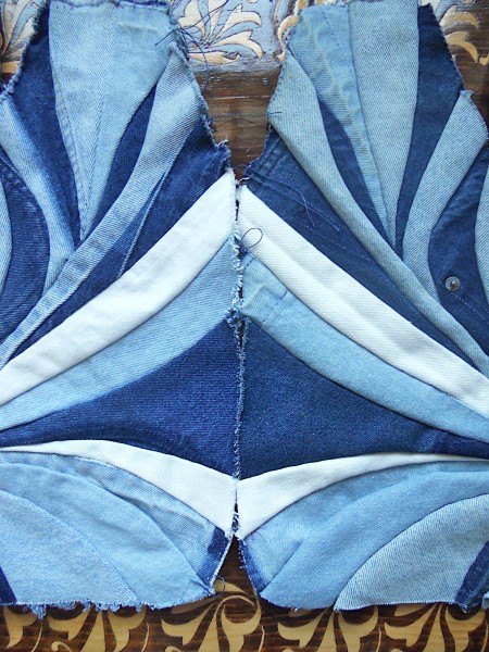Sewing the pieces of denim together.