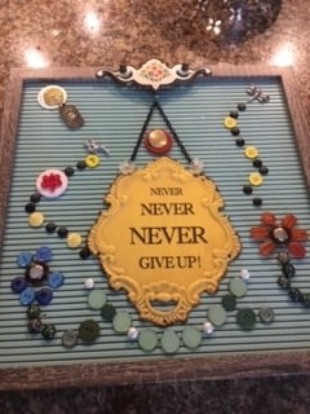 The board with flowers made from buttons.