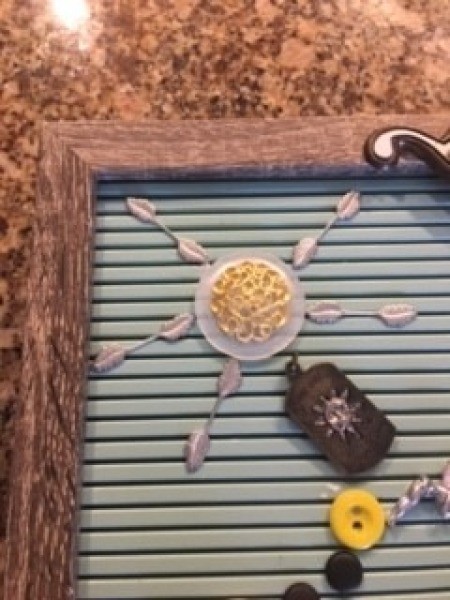 Adding decorative buttons and charms to the board.