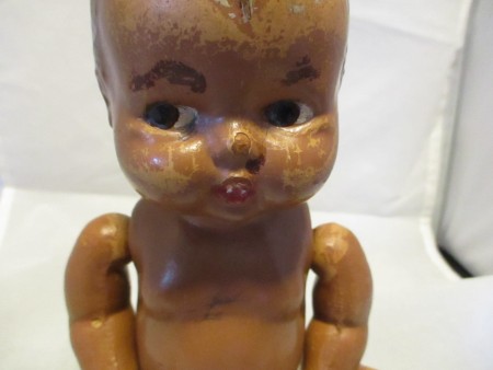 A close up of the painted face of a baby doll.