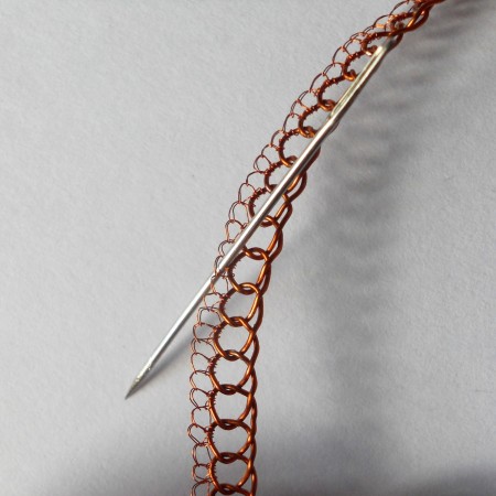 Crocheting the smaller wire to the bangle.