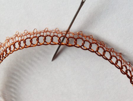 Crocheting the smaller wire to the bangle.
