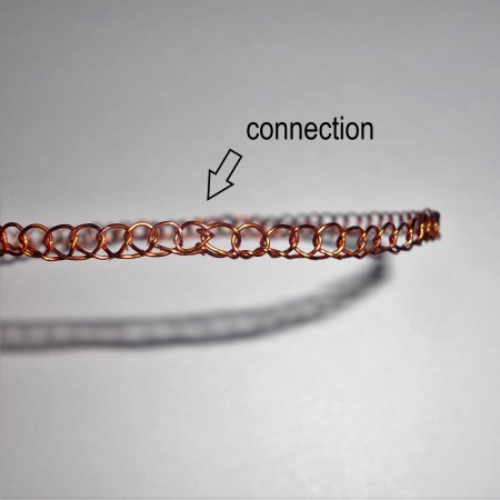 Connecting the crocheted bangle together.