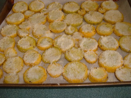 Adding parmesan to the squash rounds.