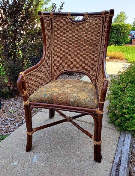 A vintage chair with a woven seat back.