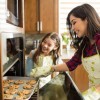 A mom and daughter making cookies.
