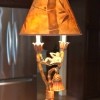 A lamp that has a monkey under the shade.