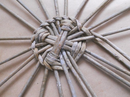 Weaving a basket with the paper tubes.