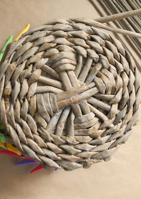 Weaving a basket with the paper tubes.
