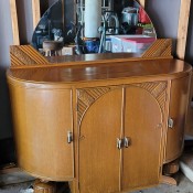 A small buffet table with a mirror.