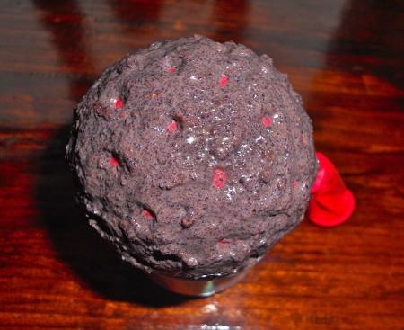 A balloon covered with coffee grounds.