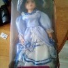 A collectible porcelain doll in a box.