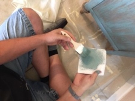 Adding paint to the buffet.