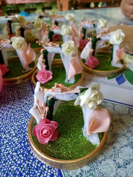 Adding rosebuds and other decorations.