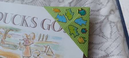 The corner bookmark in use on a book.