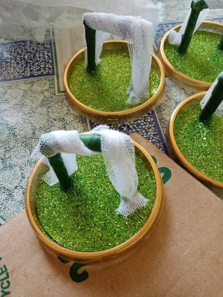 Wrapping tulle around the trellis.