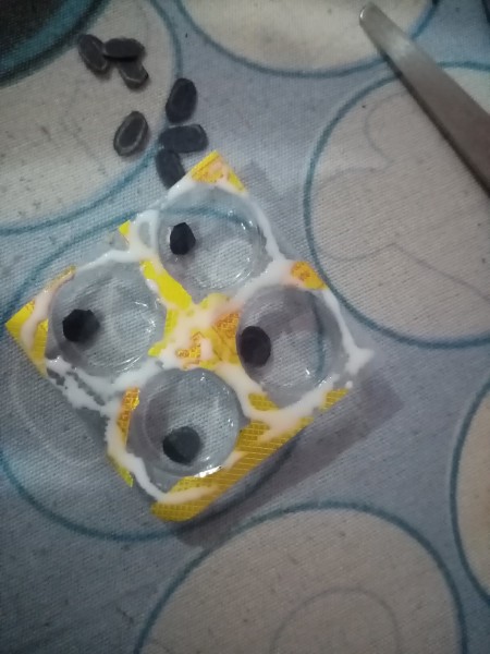 Adding the pupils to the blister packaging.