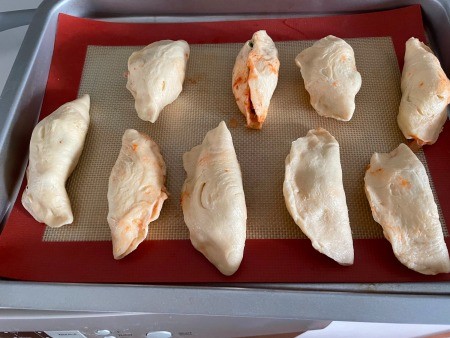 A baking sheet of homemade hot pockets.