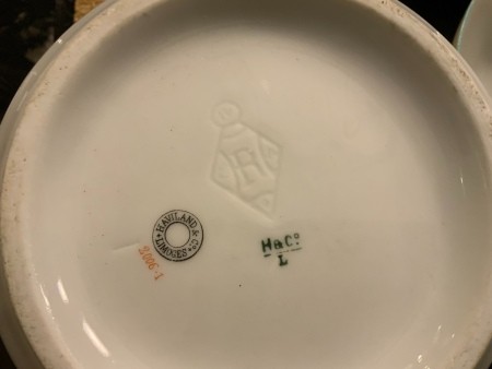 The marking on the back of a set of china.