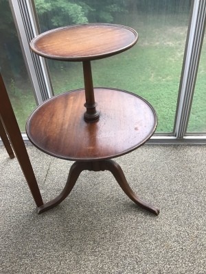 A two-tier round wooden side table.