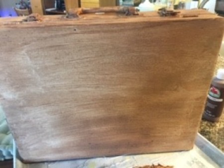 Painting the suitcase brown.