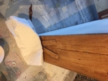 Painting the suitcase brown.