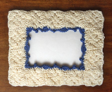 The crocheted frame with the cardboard one inserted inside.