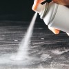 An aerosol can spraying on a surface.