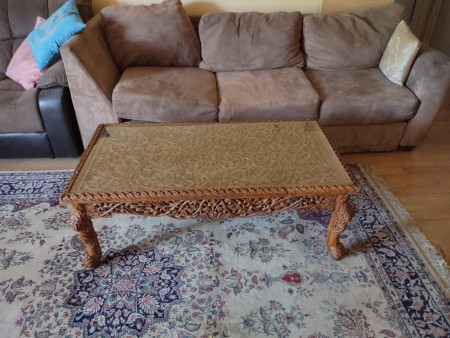 A ornately carved coffee table.
