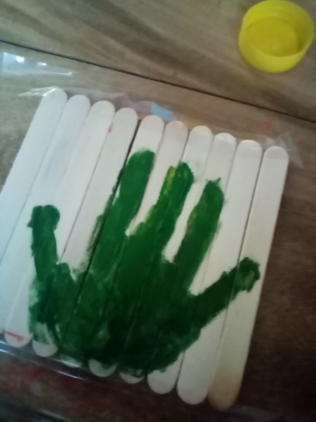 A green handprint on all the sticks.