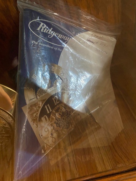 The manuals and accessories for a grandfather clock.