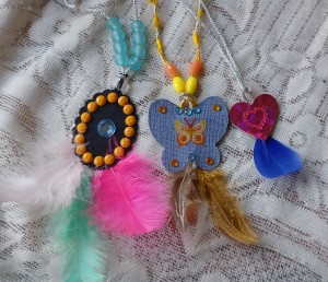 Three decorative feather pendants.