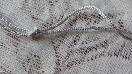 Tying a knot in the pendant cord.